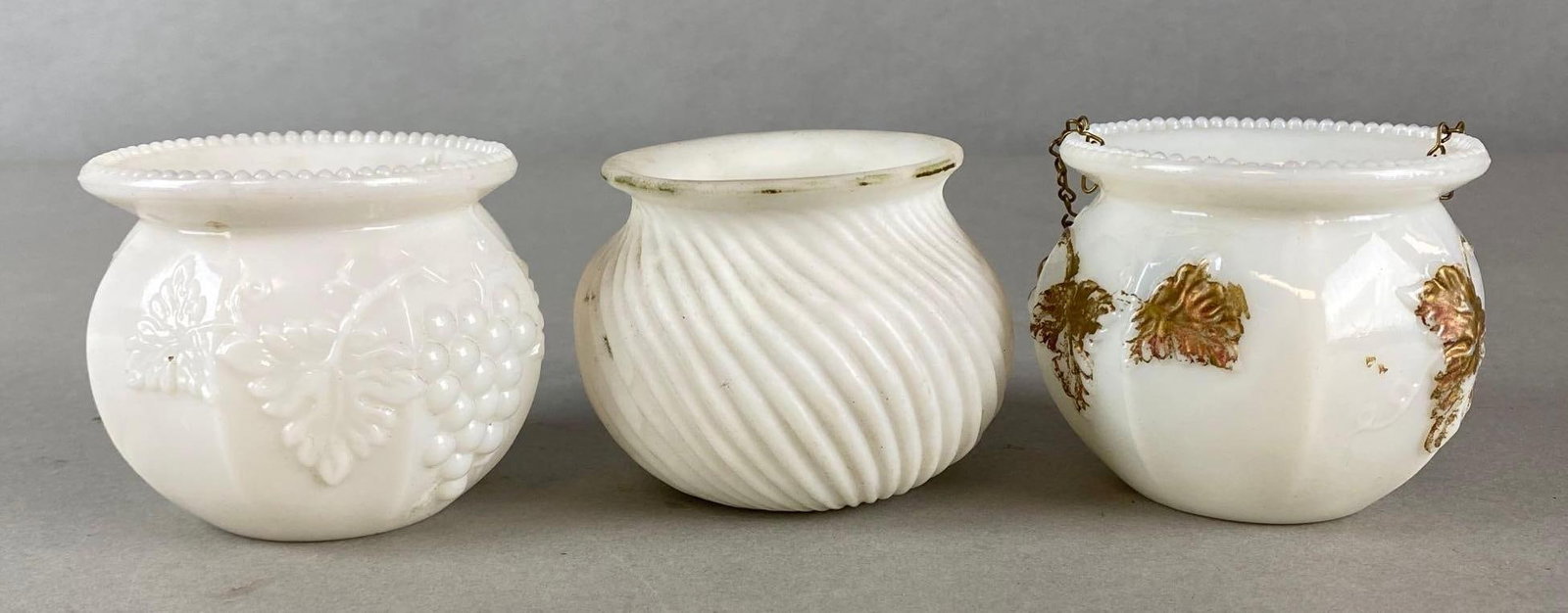 Group of 3 White Milk Glass Hanging Oil Lamp Matchstick Holders: Includes grape and cable, swirl, and grape leaves patterns, One with chains, Largest measures 2 1/2 x 3 x 3 inches.