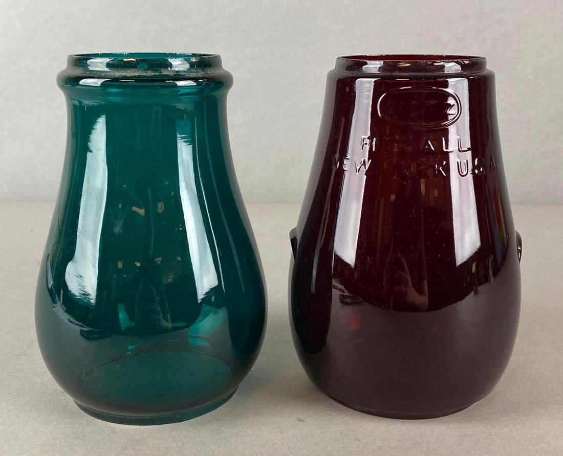 Group of 2 Colorful Glass Lantern Globes: Includes Ruby Red Glass Dietz Glass Globe, and Green Glass Globe, Some fleabites, Largest measures 6 3/4 x 4 1/2 x 4 1/2 inches.