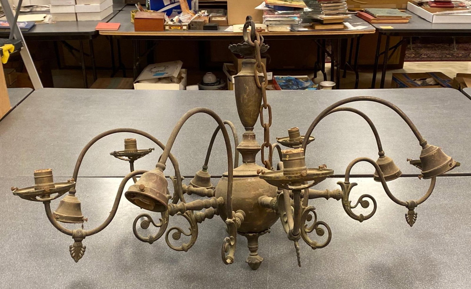 Art Nouveau 8-Arm Brass Chandelier: Electrified, Unknown working condition, Needs cleaning, Measures 22 1/2 x 36 x 36 inches.