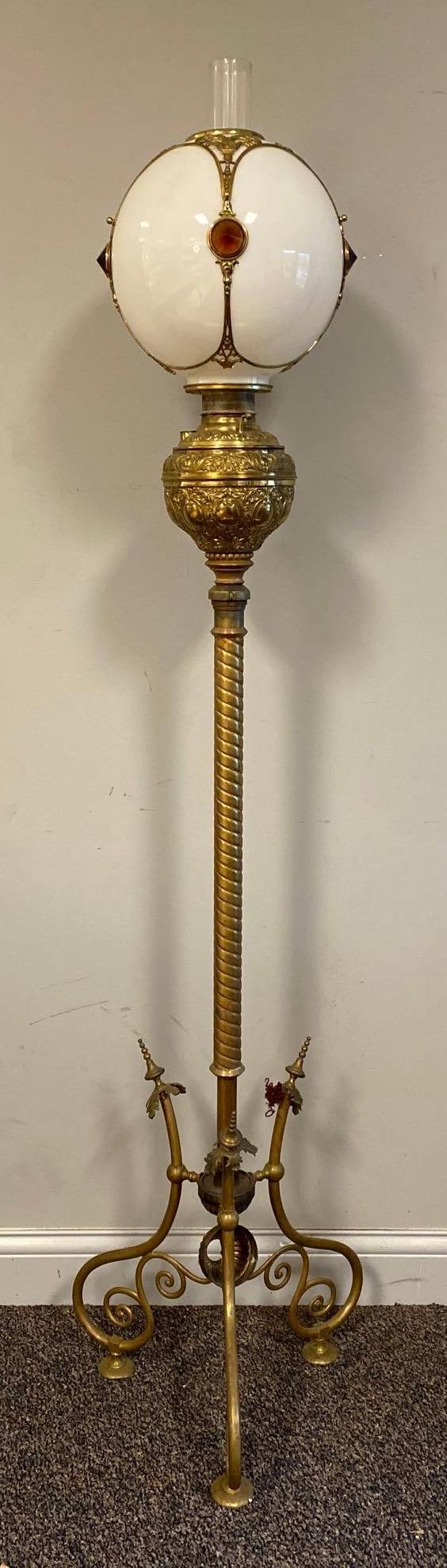 Tall Brass Standing Piano Lamp with Milk Glass Globe: No Shipping Available. Electrified, Unknown working condition, Globe with brass and reflector embellishments, Measures 70 x 17 x 17 inches.