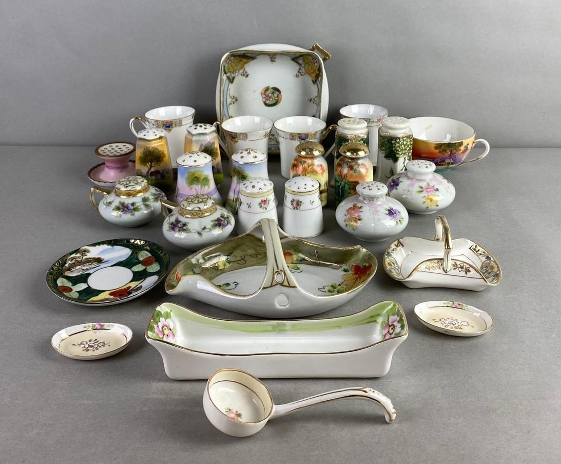 Group of 25+ Nippon Porcelain Dishes: Includes shakers, teacups, saucers and more. Condition consistent with age, largest measures 8 x 5 3/4 x 1 1/2 inches