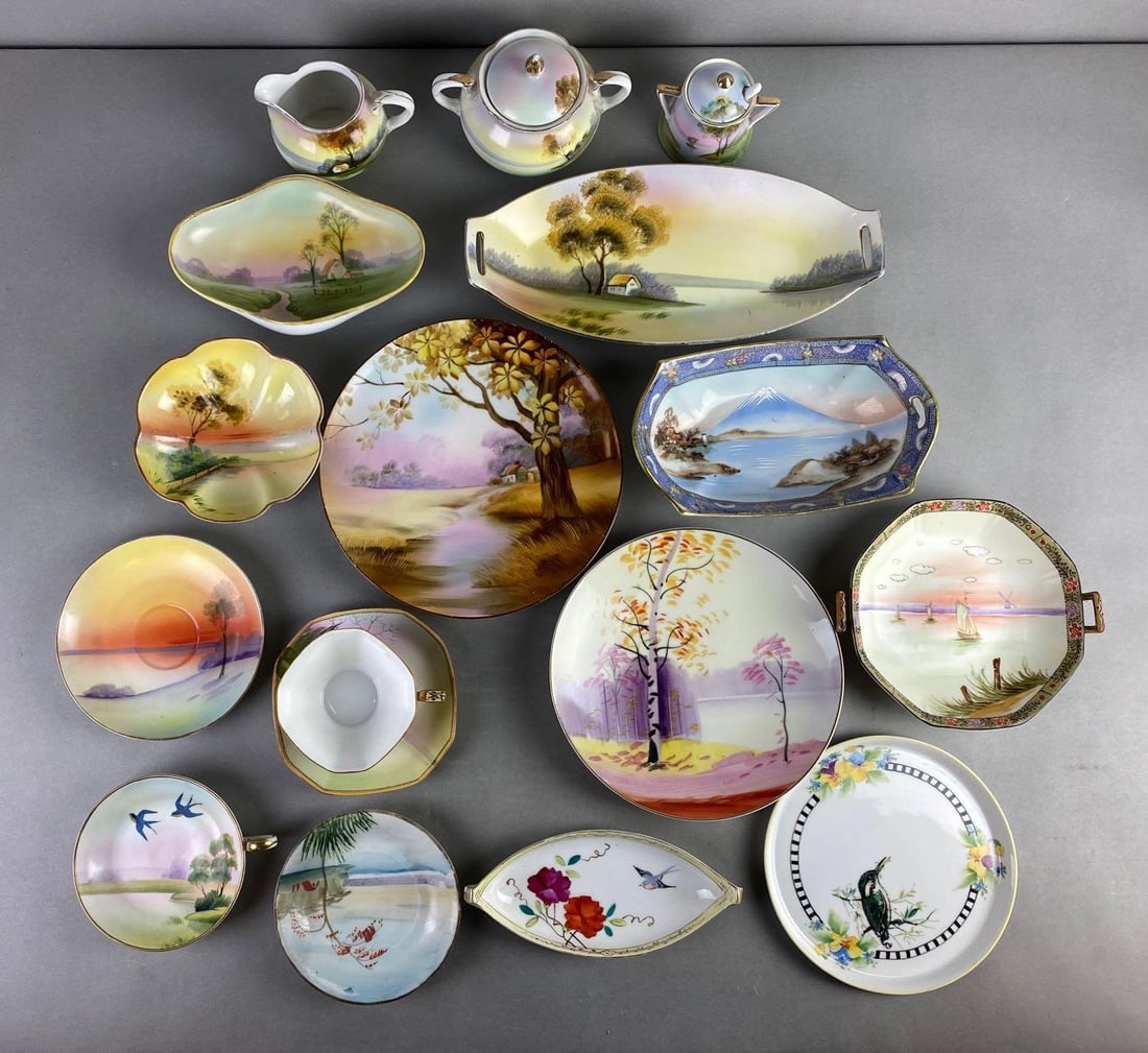 Group of 17 Hand Painted Nippon Porcelain Dishes: Includes plates, creamer and sugar, teacup and more. Condition consistent with age, largest measures 12 x 5 1/2 x 1 3/4 inches