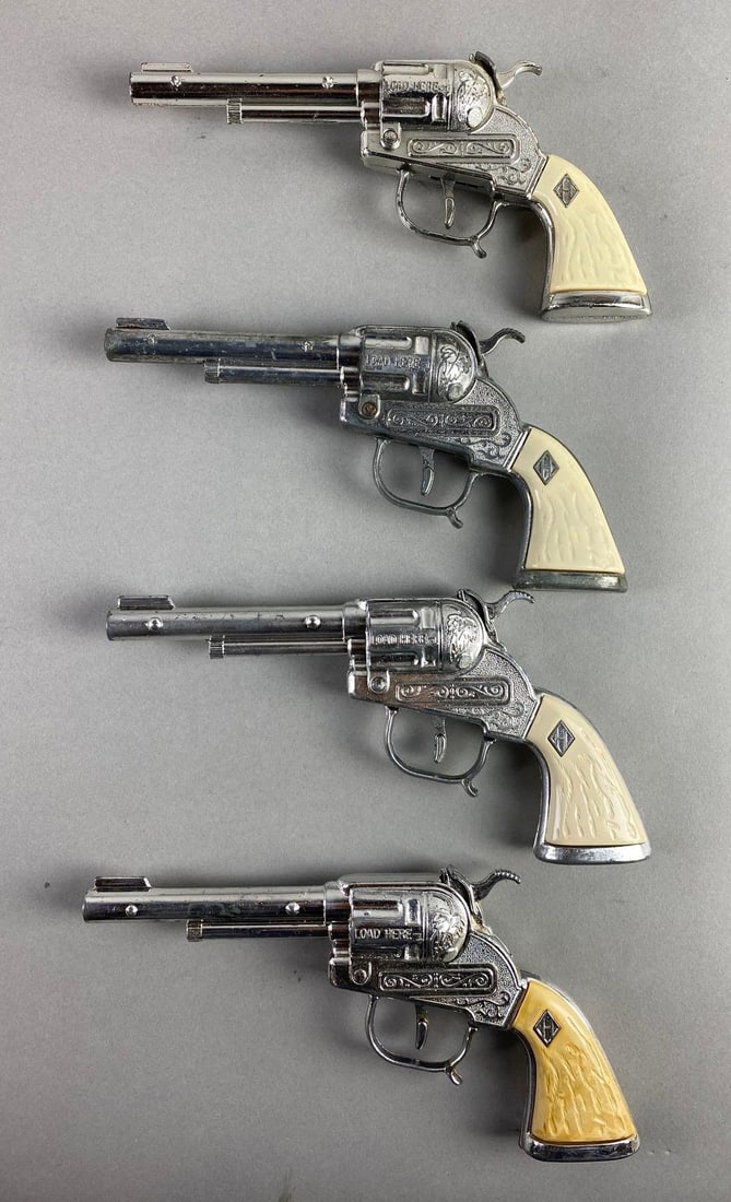 Group of 4 1960-65 Leslie Henry Repeater Cap Guns: In working condition, white stag grips, nickel die-cast body, measures 8 1/4 x 4 x 1 inches