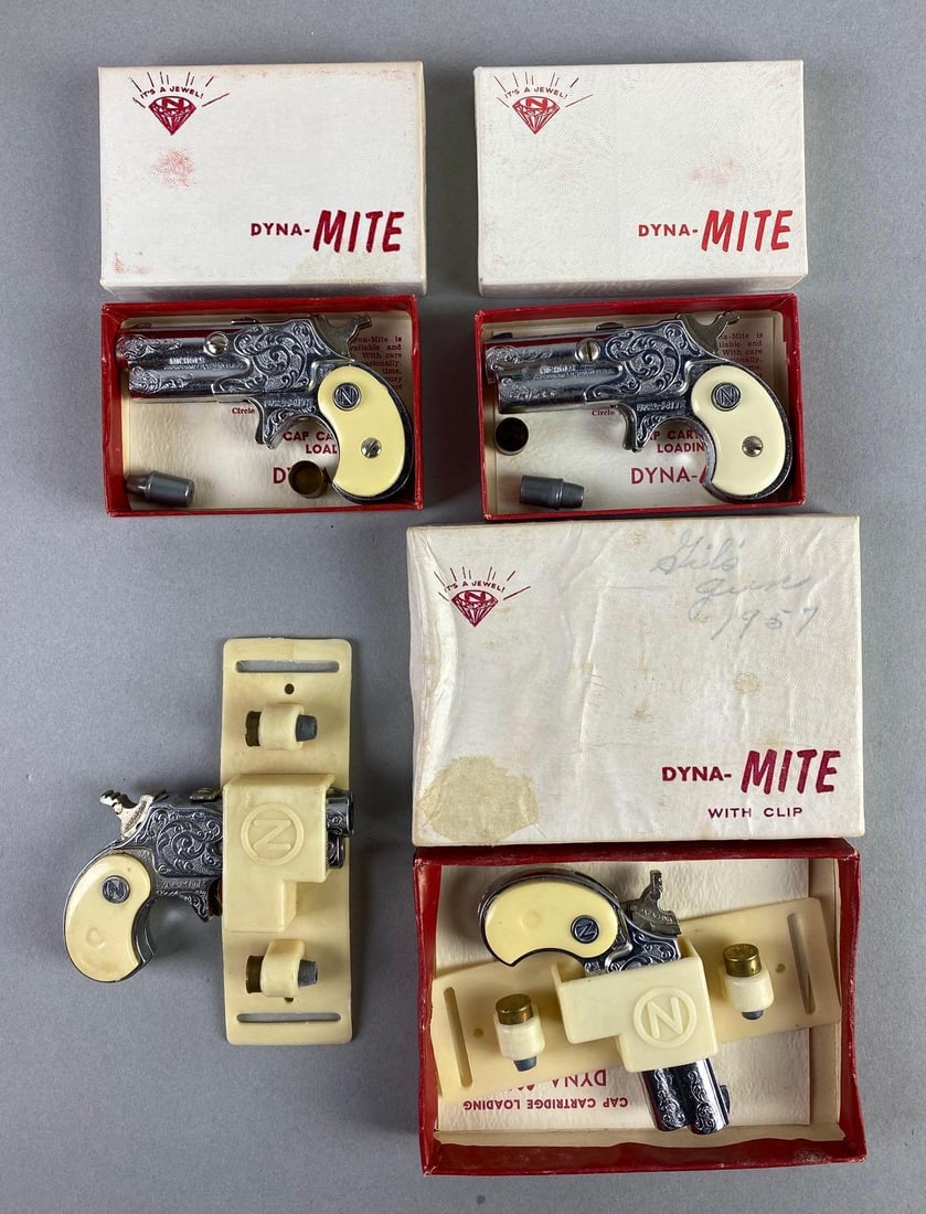 Group of 4 1950s Nichols Dyna-Mite Derringer Cap Guns: In working condition, 3 with original boxes, measures 3 1/4 x 2 x 3/4 inches