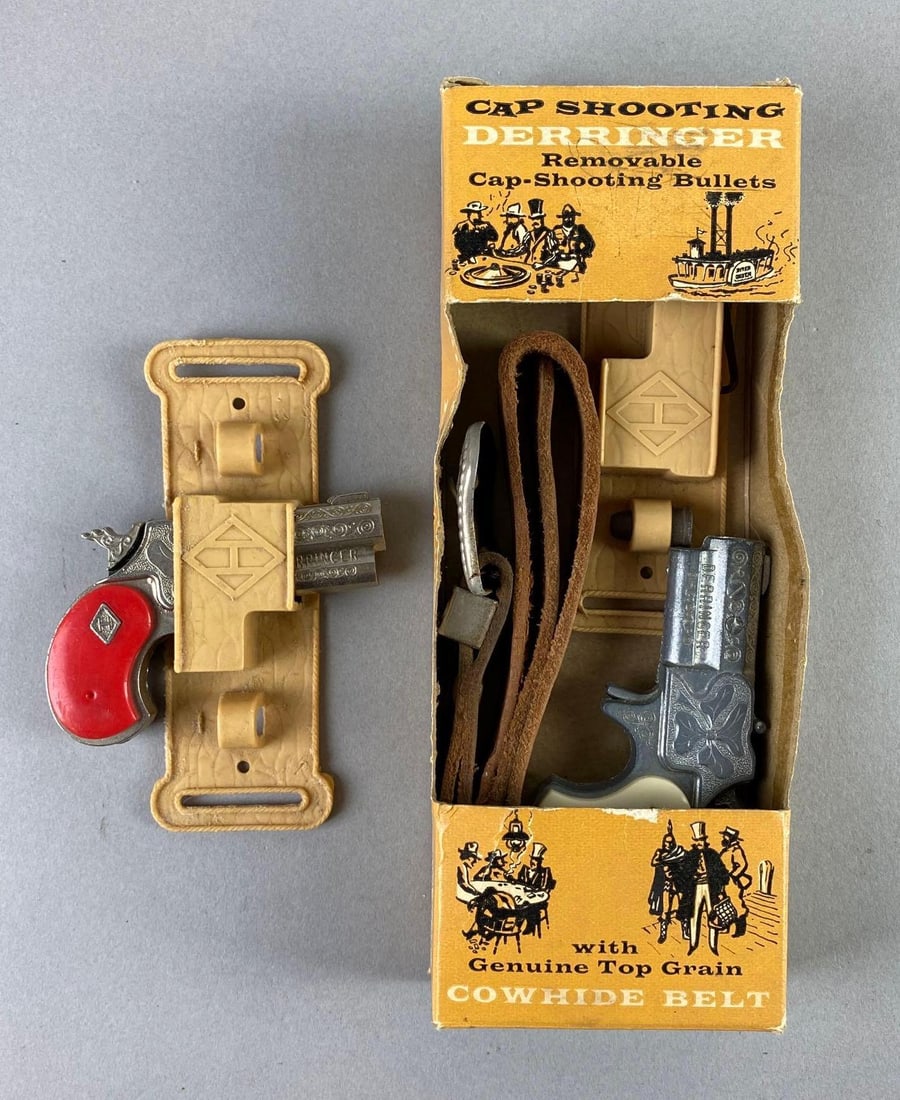 Group of 2 1950s Leslie Henry Derringer Cap Guns: In working condition, 1 with original box, measures 3 1/4 x 2 1/4 x 3/4 inches