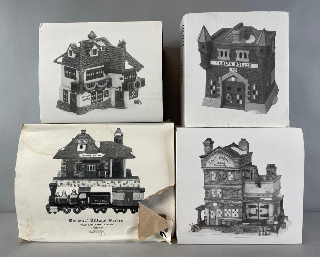 Group of 4 Department 56 Dickens Village Buildings: Like new in box. Includes train and lighted station, East Indies trading co, cobbles police station, and mr wickfield solicitor. Largest measures 10 x 12 1/2 x 7 inches