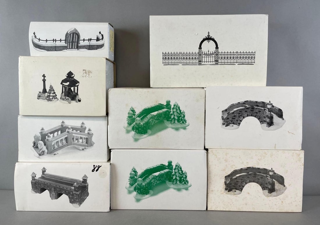 Group of 9 Department 56 Heritage Village Accessories: Like new in box. Includes stone bridges, Victorian wrought iron fence and gate, village well and holy cross, and more. Largest measures 7 x 11 x 2 inches