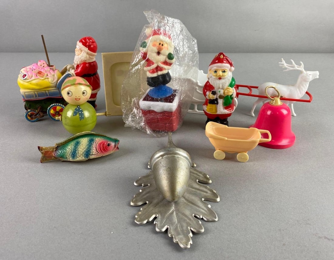 Group of 10 Vintage Christmas Decorations: Includes Santa Claus, reindeer and sleigh, candle holder, and more. Largest measures 8 1/2 x 3 1/4 x 2 inches