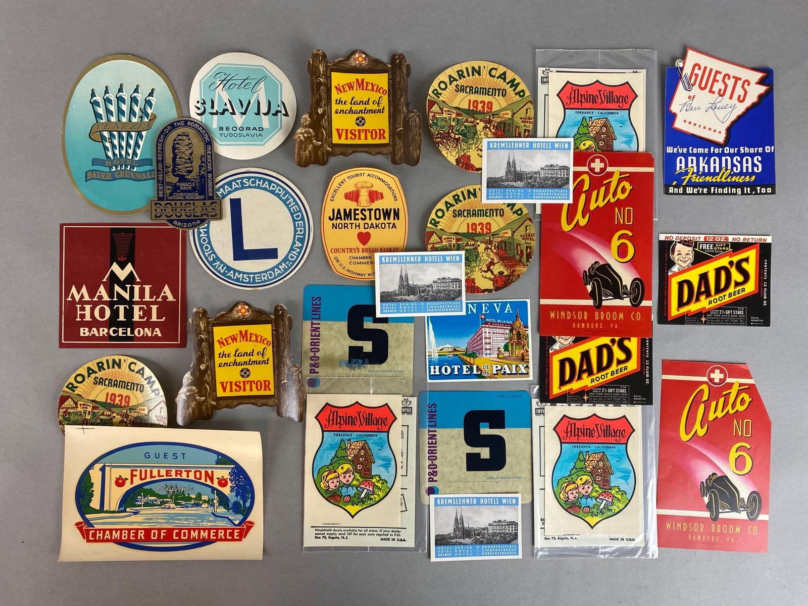 Group of 20+ Assorted Advertising Travel Decals: Includes Dads Root Beer, Manila Hotel Barcelona, New Mexico, and more, Largest measures 4 1/4 x 6 inches.