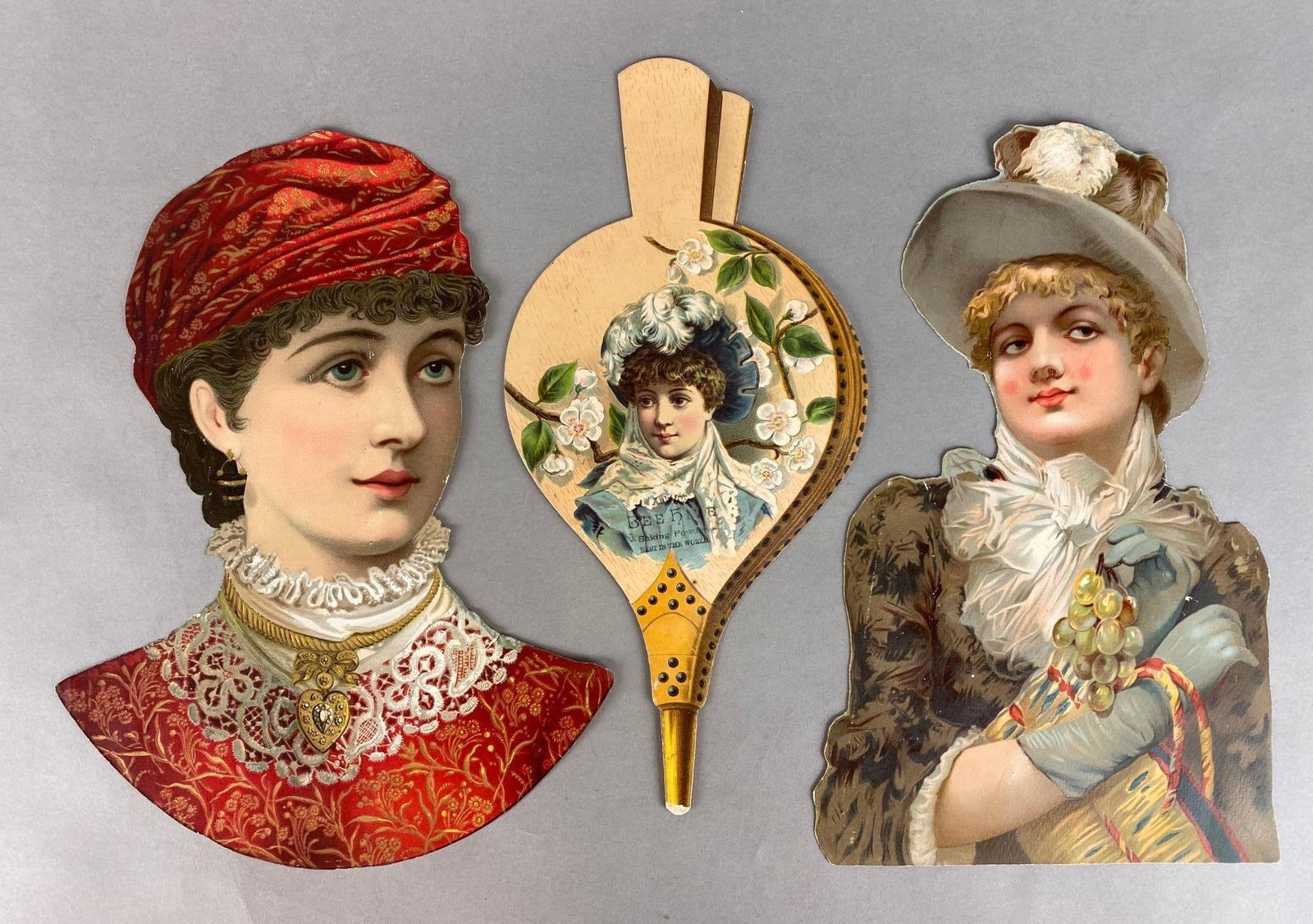 Group of 3 Large Victorian Women Die-Cuts: Includes (2) women, and (1) bellows, Largest measures 13 1/2 x 10 inches.