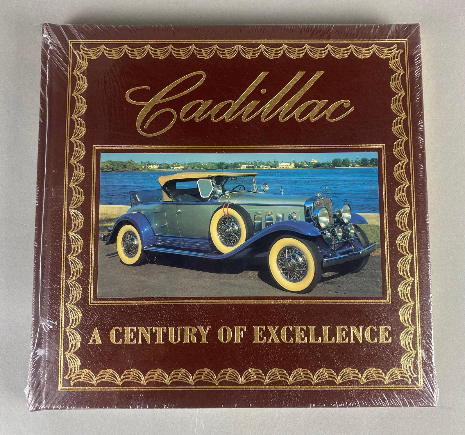Cadillac A Century of Excellence Easton Press Book: Rob Leicester Wagner. Sealed in plastic. Leather stamped gilt with gilt edges.
