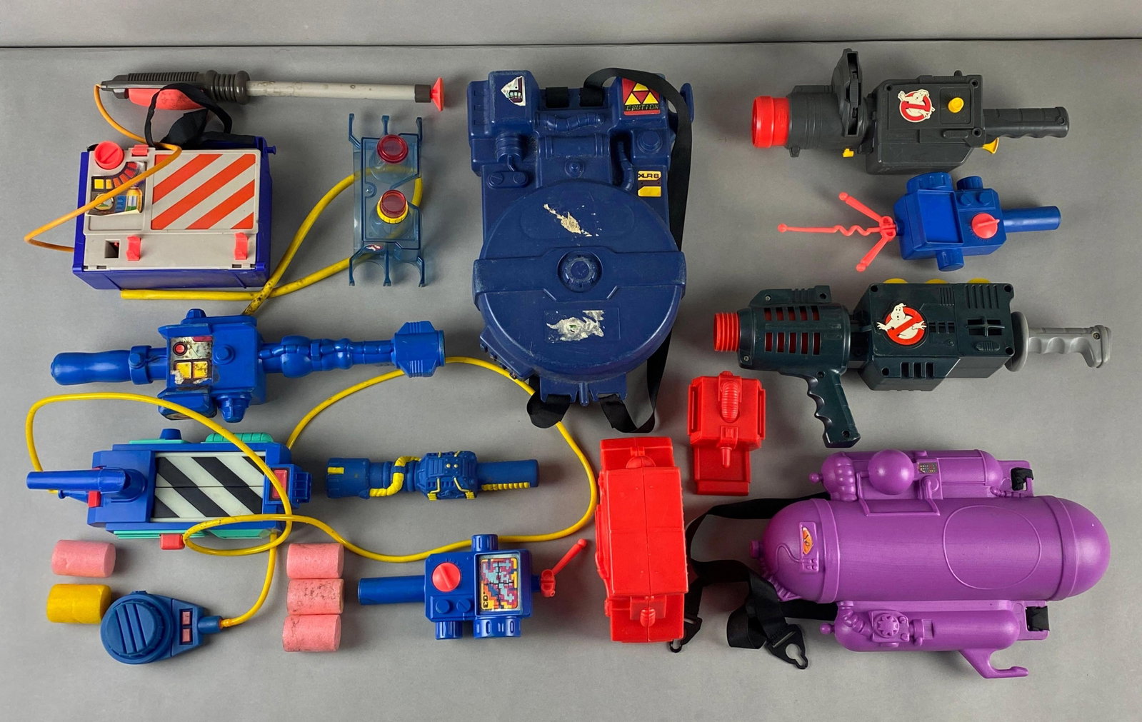 Vintage Group of 1980s Ghostbusters Action Toys: Includes a Kenner Proton Ghost Popper Gun among other items. Mixed condition and contents. Largest item measures 14 x 8 x 4 inches.