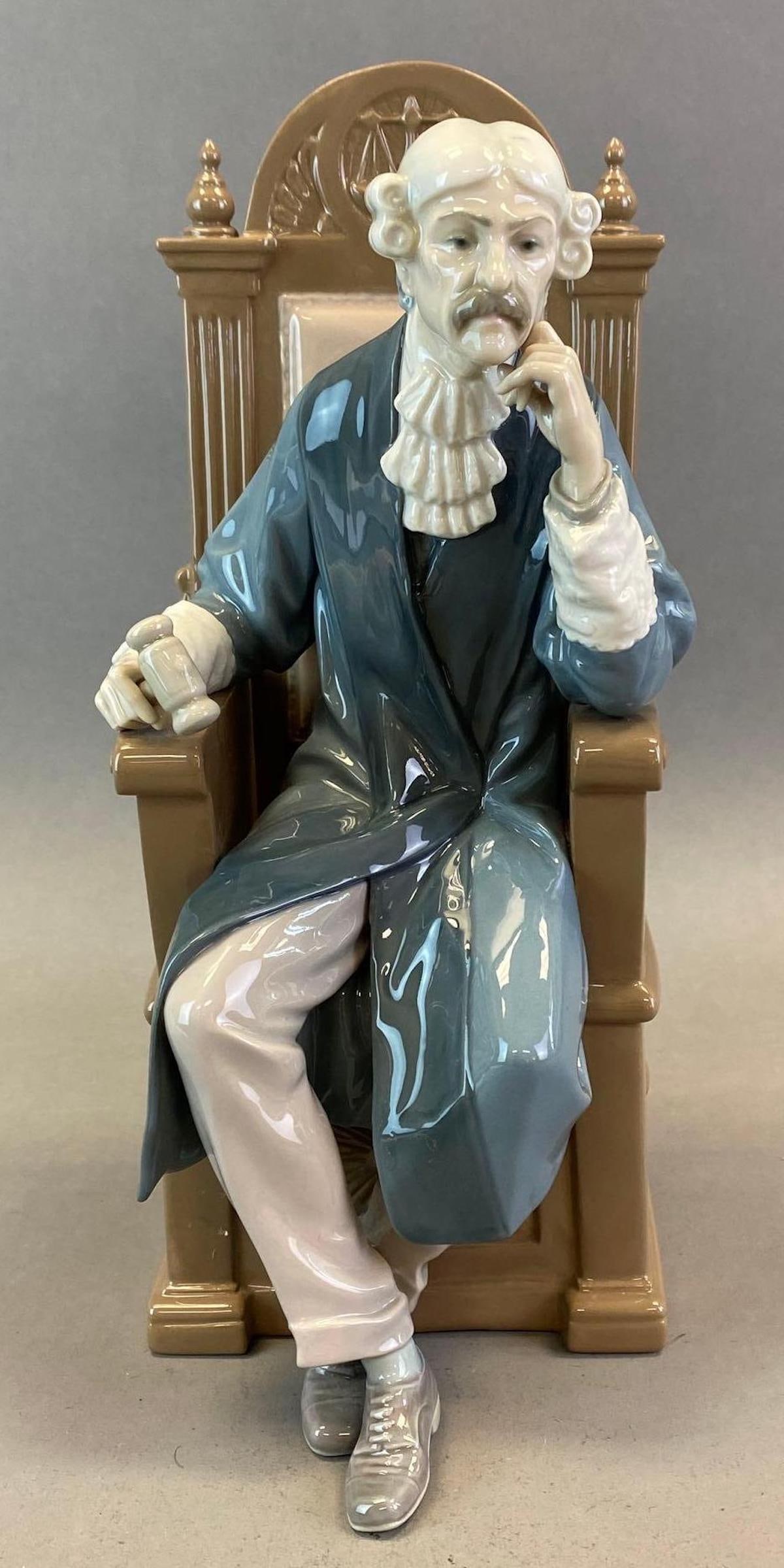 Lladro Porcelain Judge Figurine: Made in Spain, Makers mark on base, Artists signatures on base, No. 709, Measures 12 1/4 x 5 1/2 x 7in.
