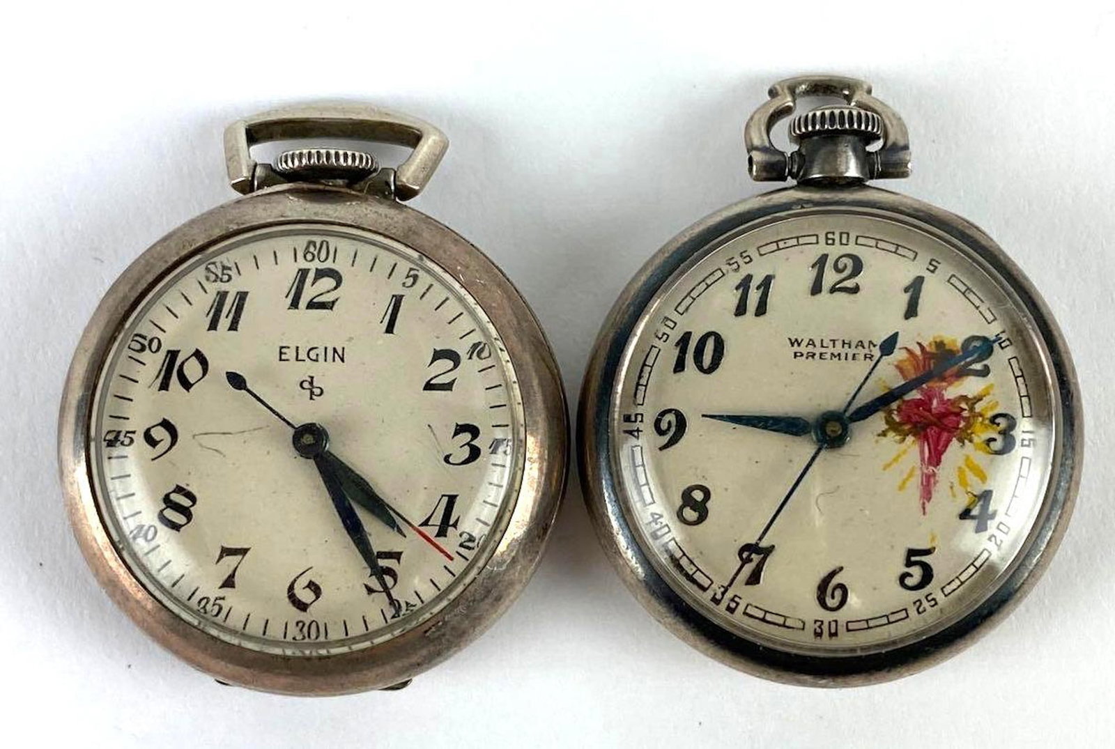 Group of 2 Antique Sterling Silver Open Face Pocket Watches: Includes Elgin 16 jewels and Waltham 18 jewels, in working condition, weighs 35.0g total weight, largest measures 1.003 inches across