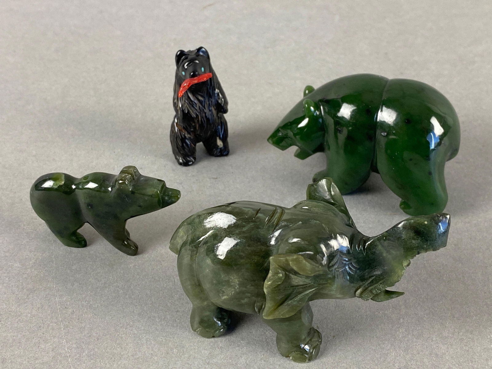 Group of 4 Carved Animal Figures Green Jade Bears and Elephant: The black bear is stone but not green Jade. Elephant measures 2 x 1 1/4 x 3 inches.