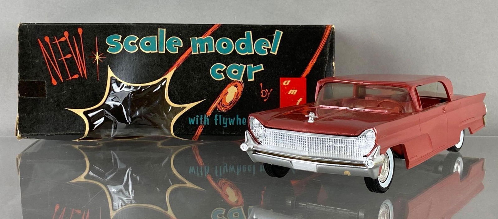 AMT 1959 Lincoln Continental Mark 4 Dealership Promo Car: Original box. Rose, with friction wheels working condition. Measures 9 x 3 x 2 1/2 inches.