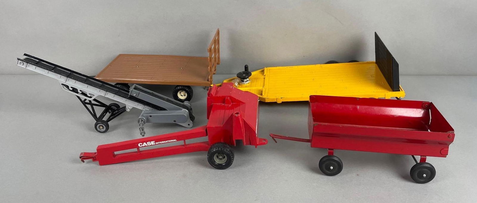 Group of 5 Ertl Die-Cast Farm Tractor Attachments: Includes bailer, conveyor belt, case international. Largest measures 5 x 16 1/2 x 8 1/2 inches