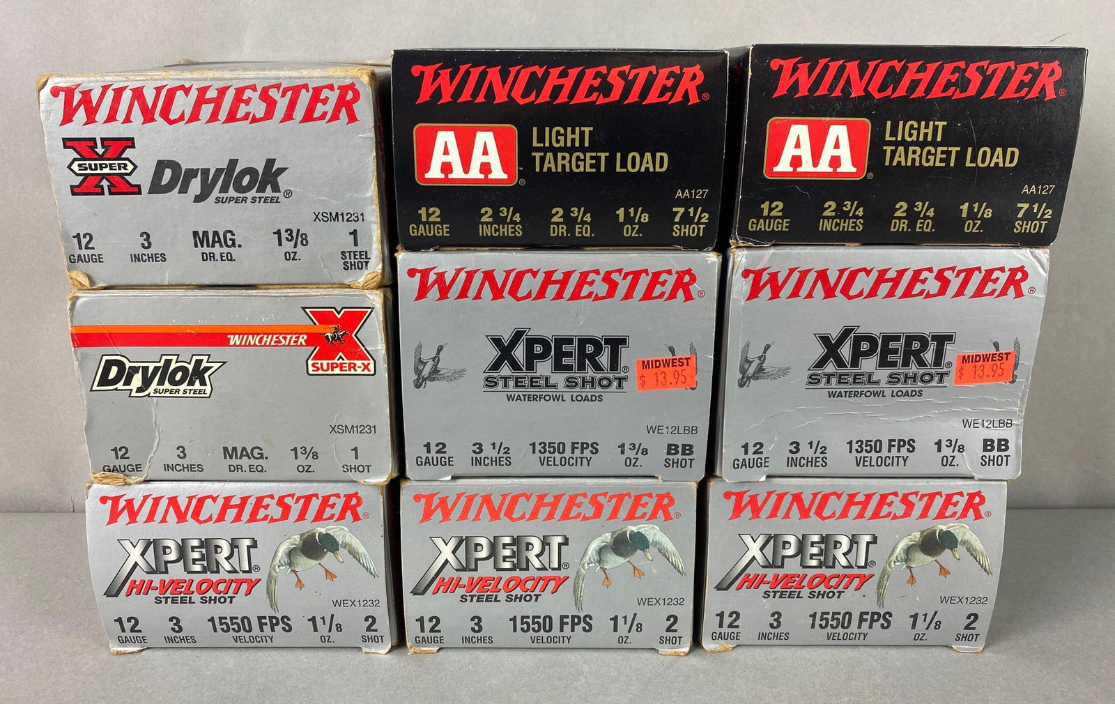 9 Boxes of Winchester 12 Gauge Shotgun Ammunition: Includes 2 boxes of 1350 FPS 1 3/8oz BB, 3 boxes 1550 FPS 1 1/8oz 2 shot, 2 boxes 2 3/4 Dr. Eq. 1 1/8oz 7 1/2 shot and 2 boxes Mag 1 3/8oz 1 shot. Largest box measures 4 1/2 x 4 1/4 x 3 1/4 inches.