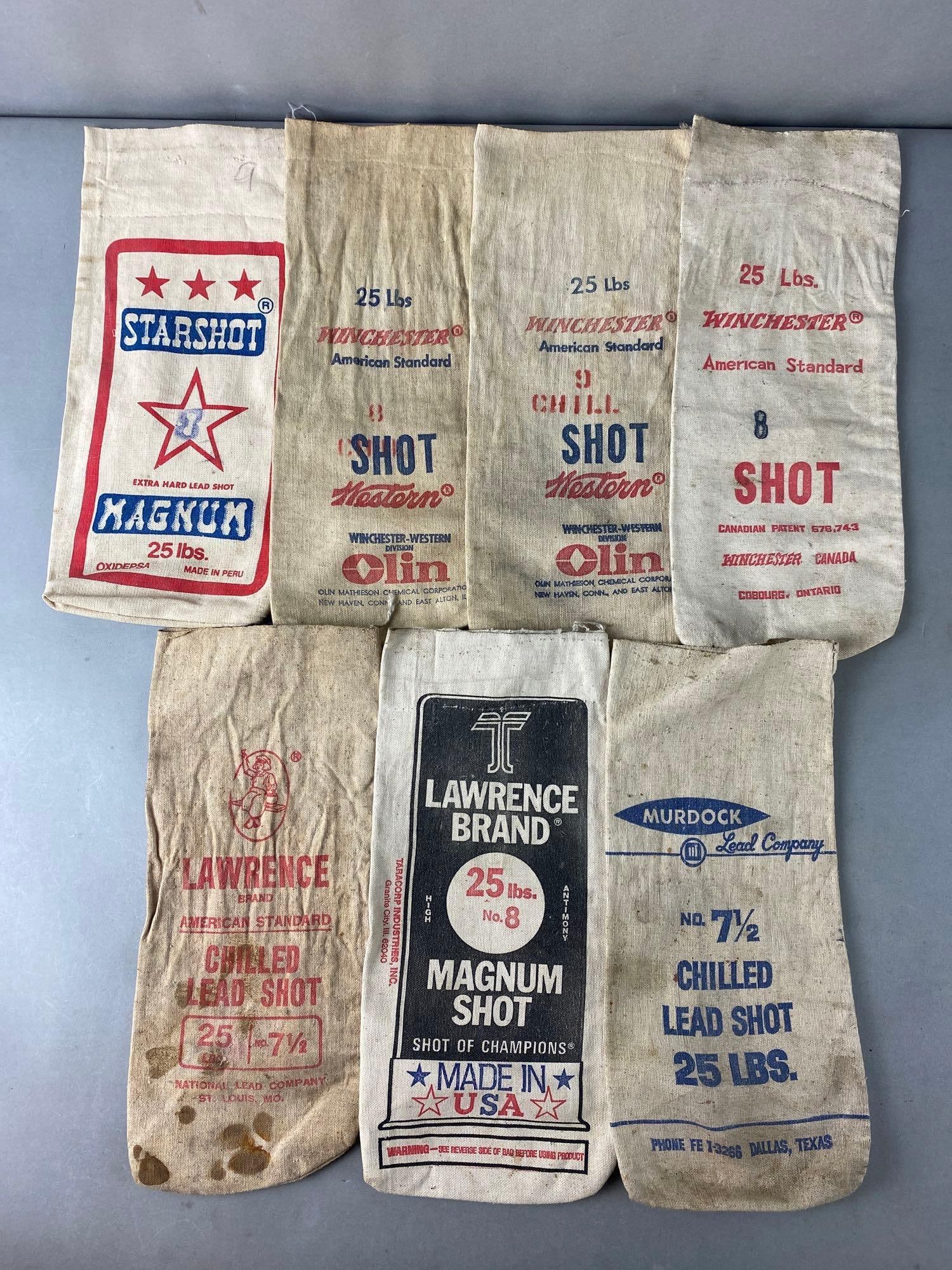 Group of Lead Shot Canvas Bags: Includees Winchester Lawrence Murdock Starshot Magnum. Total of 7 bags. Condition mixed with soiling. Largest measures 14 x 6 inches.