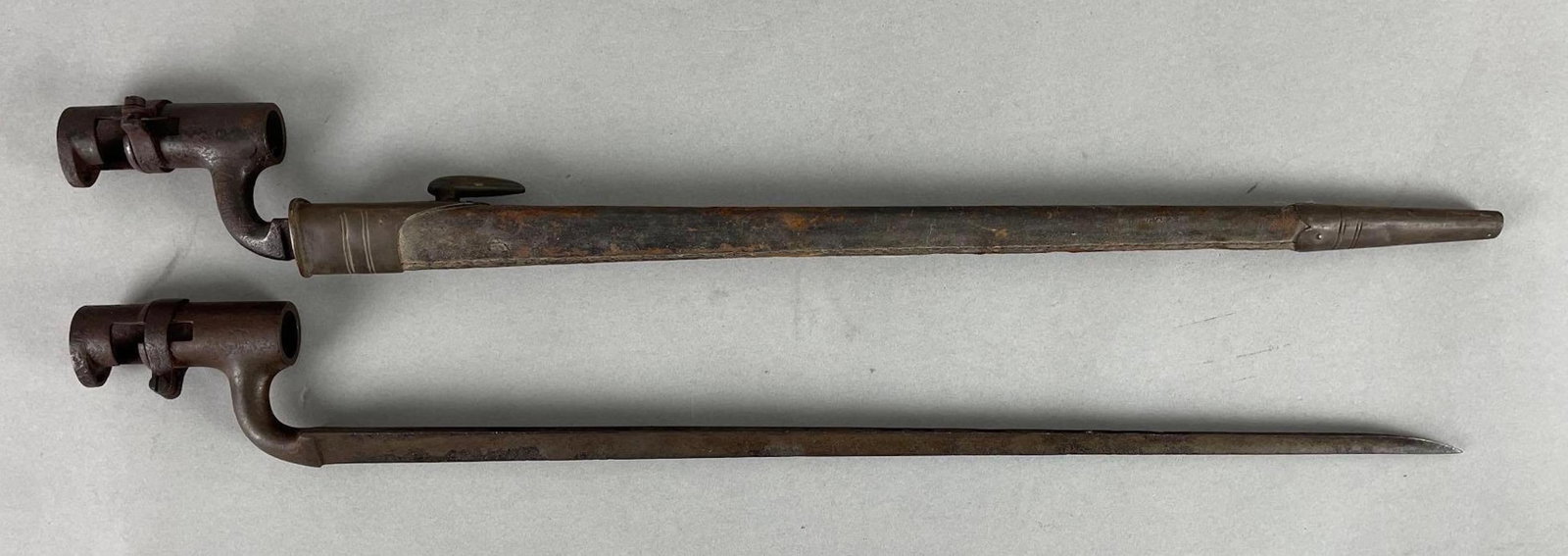 Group of 2 Antique British Triangle Bayonets: Includes one scabbard. Measure 21 inches long