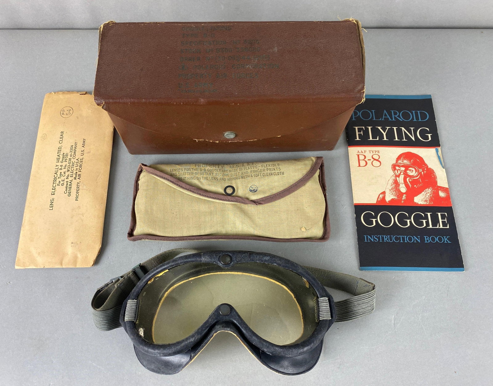 WW2 US Polaroid B-8 Goggles Lenses and Box: Spec no. 3200. Goggles, lenses and box have wear. Box measures 5 x 9 x 3 1/2 inches.