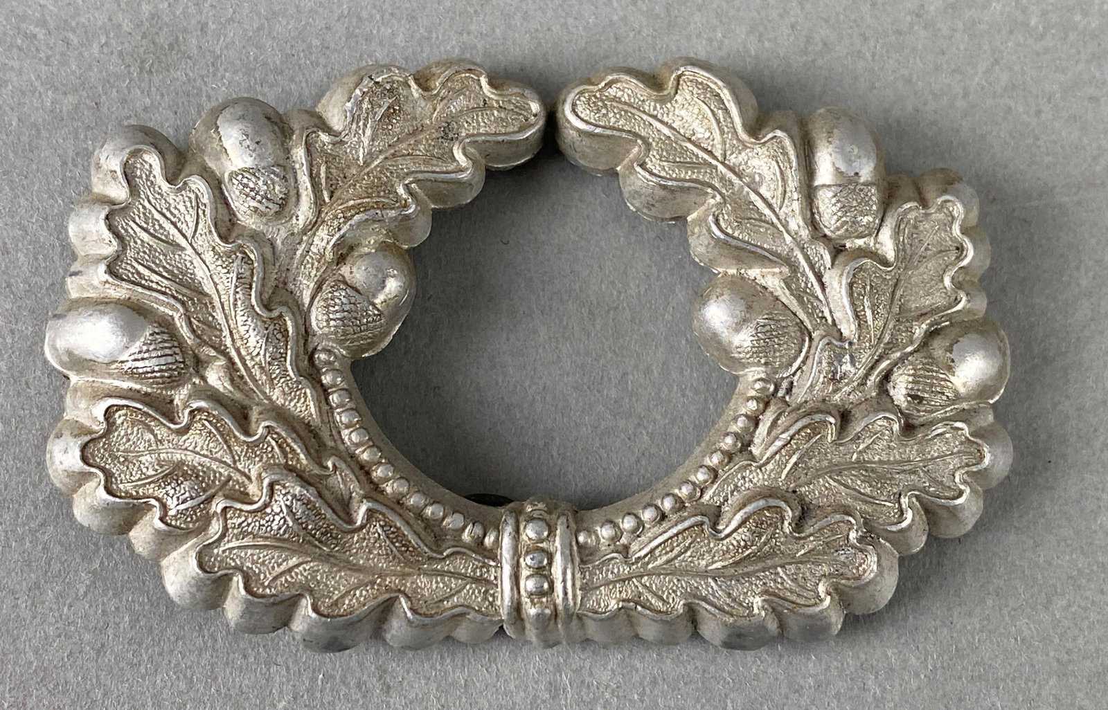 WW2 German Army Visor Cap Wreath: Aluminum. Measures 2 x 3 inches.