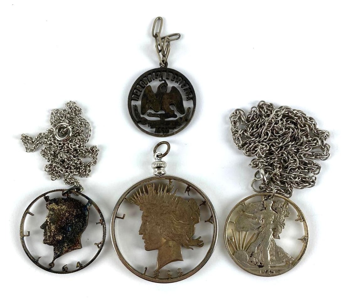 Group of (4) Cut-Out Coin Necklace Pendants: includes Peace Silver Dollar, Kennedy Silver Half Dollar, and more. Largest pendant measures 2 X 1 1/2 inches