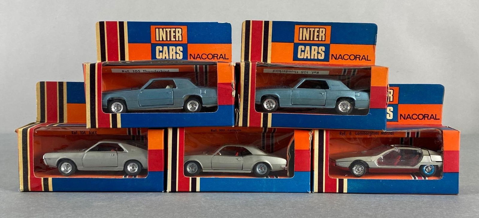 Group of 5 Nacoral Inter Cars Die-Cast Vehicles: Includes No. 104 AMX, No. 103 Camaro, No. 6 Lamborghini Marzal, and No. 105 Thunderbird, In original boxes, Boxes measure 4 x 5 x 1 3/4 inches.