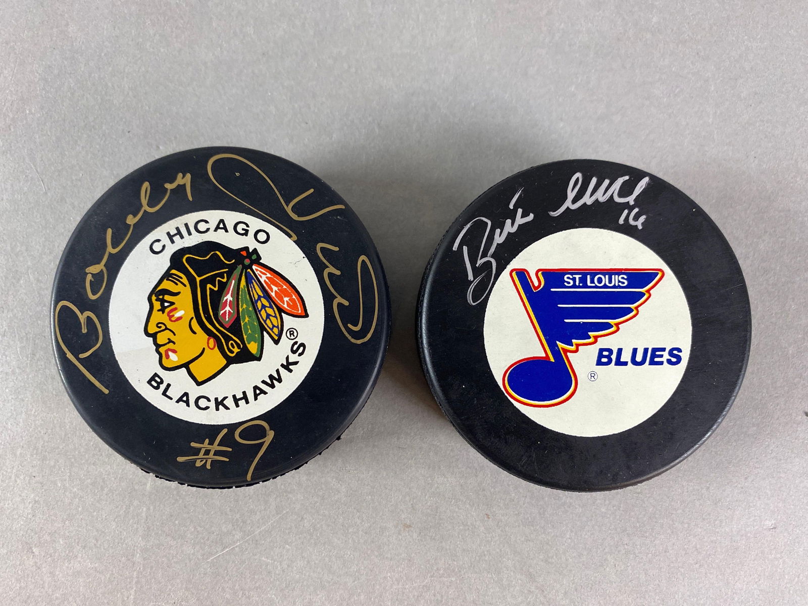 Bobby and Brett Hull Signed Hockey Pucks (1 of 2)