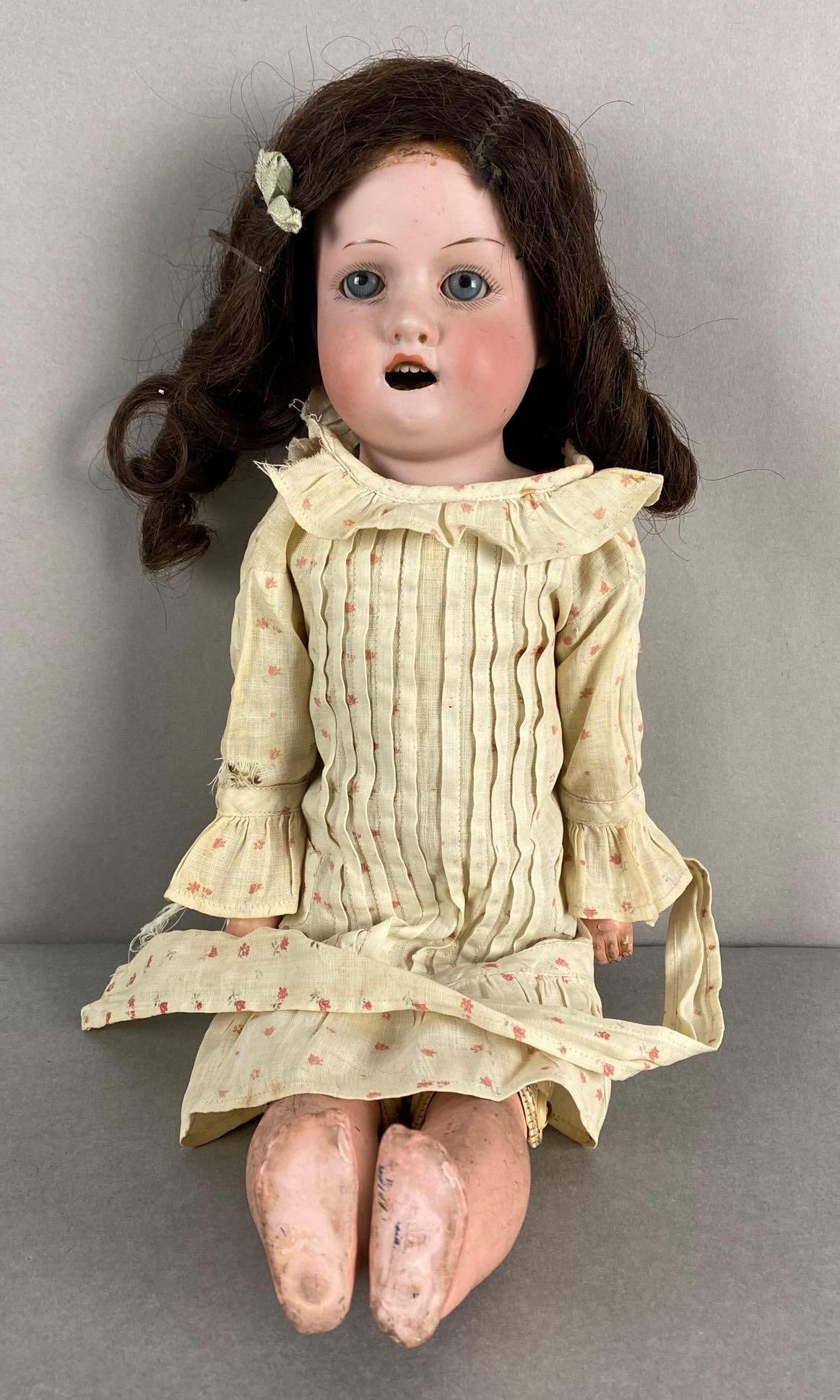 German Armand and Marseille Bisque Doll: Makers mark on back of neck, No. 370, Wig not attached, Composite body, Some broken fingers, Measures 15 inches tall.