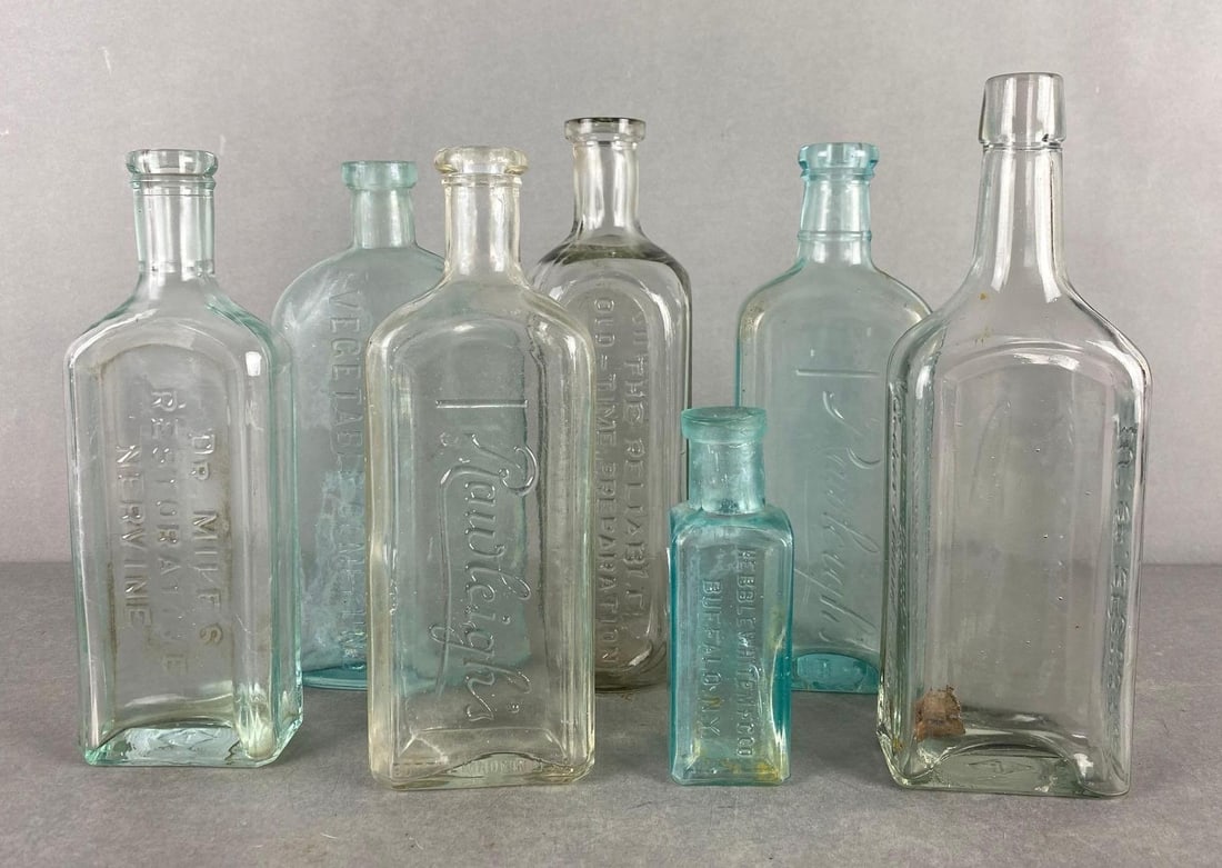 Group of 7 Glass Bottles: Includes Rawleighs, dr miles and more, largest measures 9 1/4 x 3 x 1 3/4 inches