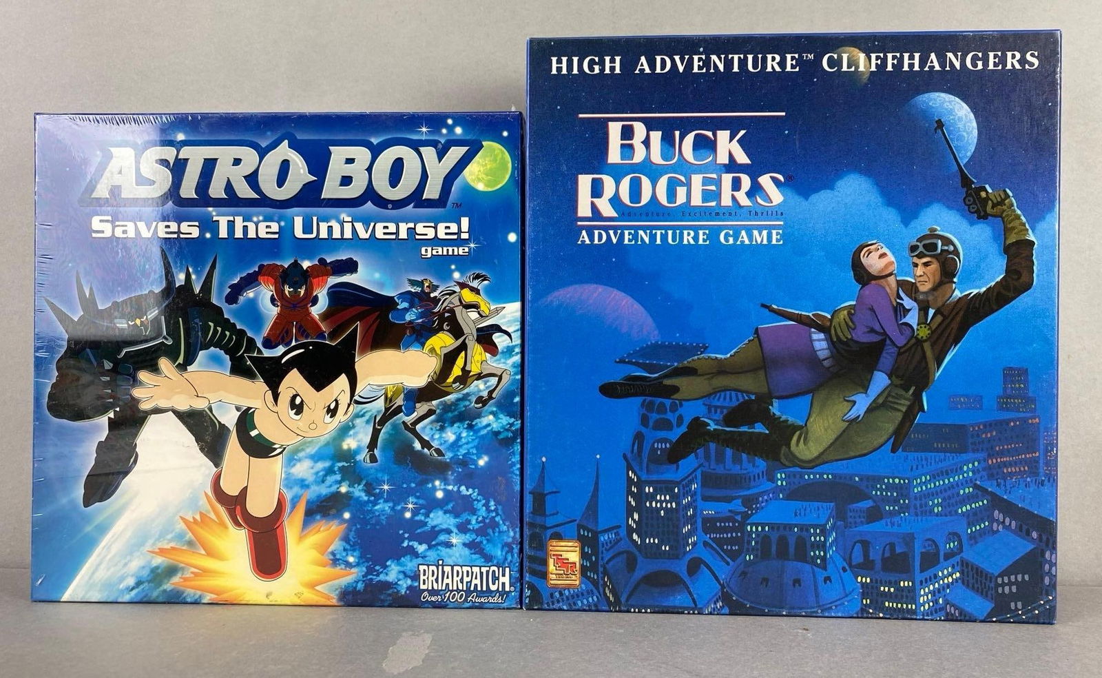 Group of 2 Pop Culture Board Games: Includes Astro Boy and Buck Rodgers, largest measures 12 x 11 x 2 inches