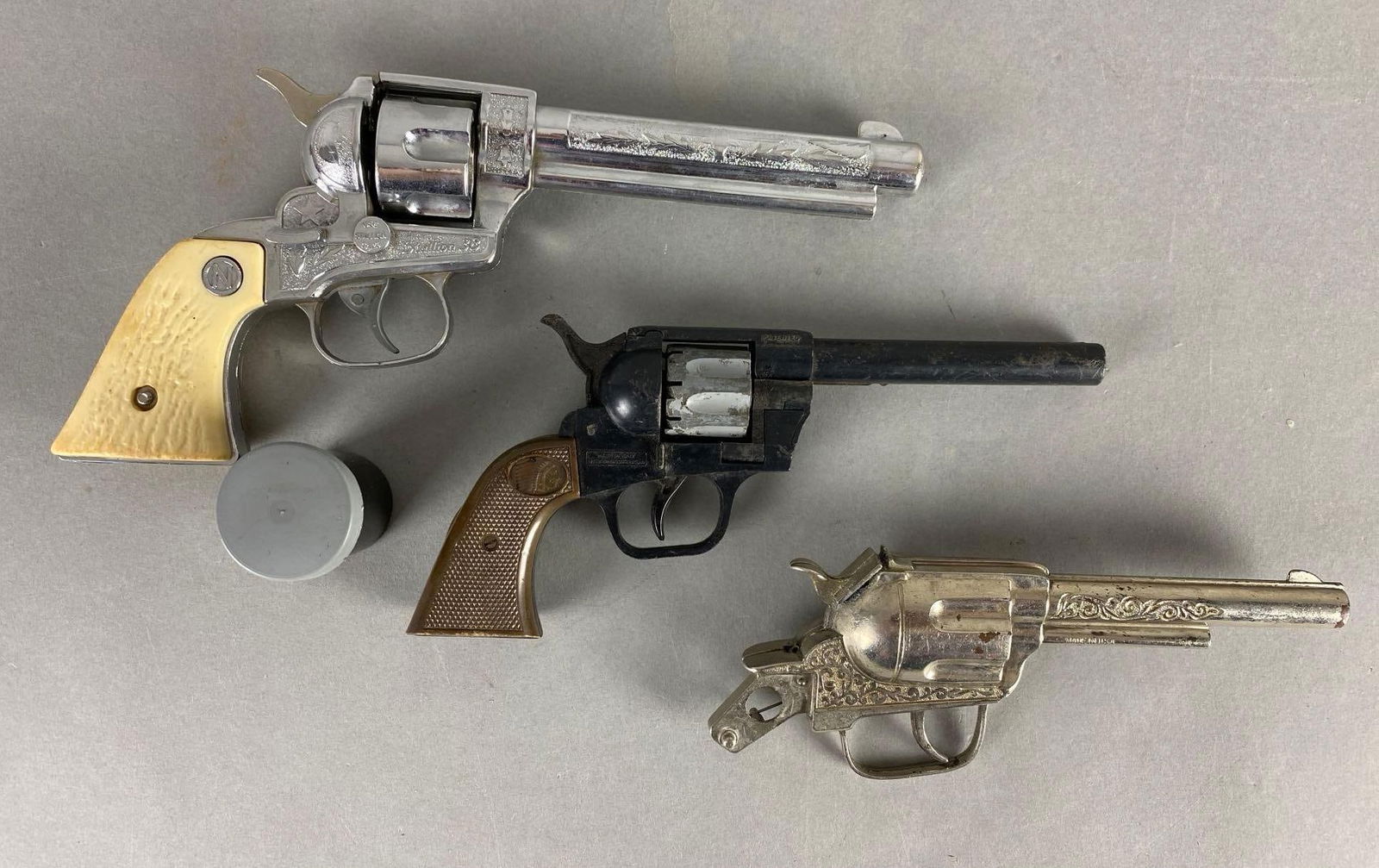 Group of 3 Cap Guns and More: Missing parts, largest measures 10 x 4 3/4 inches