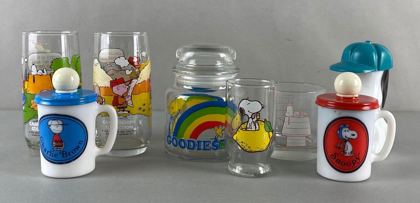 Group of 8 Peanuts Snoopy Glasses and More: Includes McDonalds Camp Snoopy Collection, Goodies Jar, Avon bottle, and more, Tallest measures 6 inches tall.