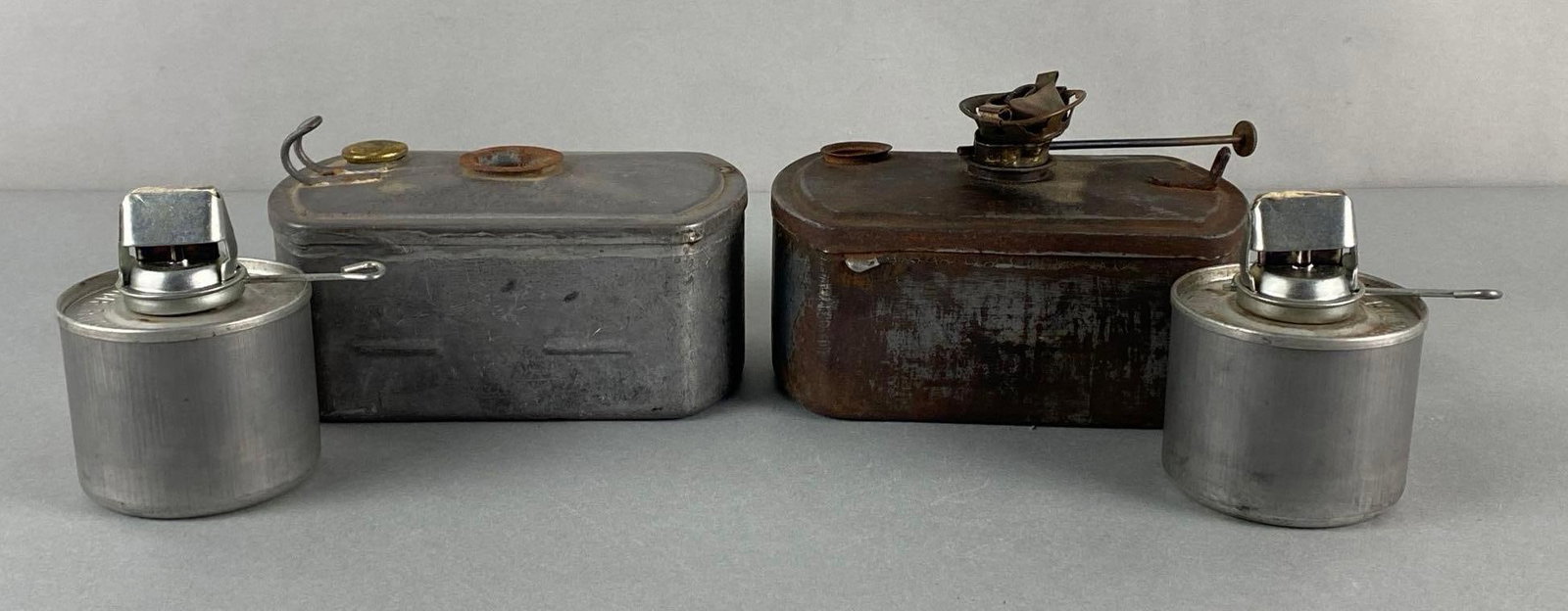 Group of 4 Aluminum Oil Lamp Reservoirs: Includes The Adams and Westlake Co, Andla, and Adlake 400, Largest measures 4 1/4 x 6 1/4 x 4 inches.