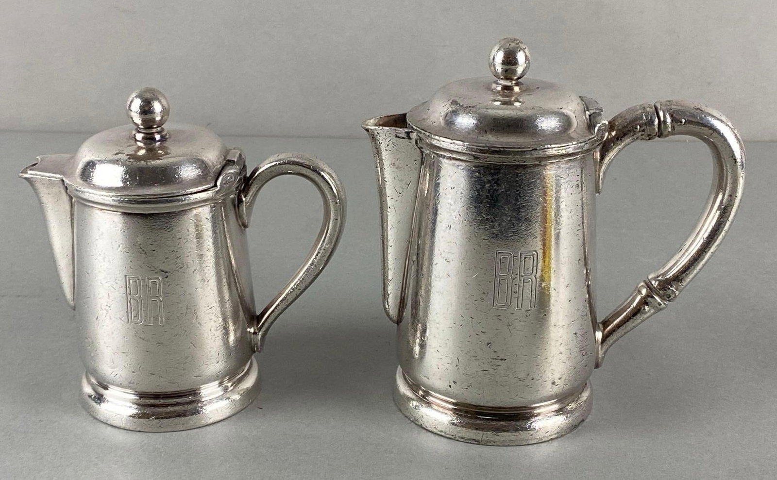 Group of 2 Burlington Route Railroad Reed & Barton Silver Soldered Cream and Sugar Set: Includes Coffee pot, and Creamer, No. 3700 B3, Property of CB&Q Railroad marked on bases, Largest measures 6 x 5 3/4 x 3 1/4 inches.