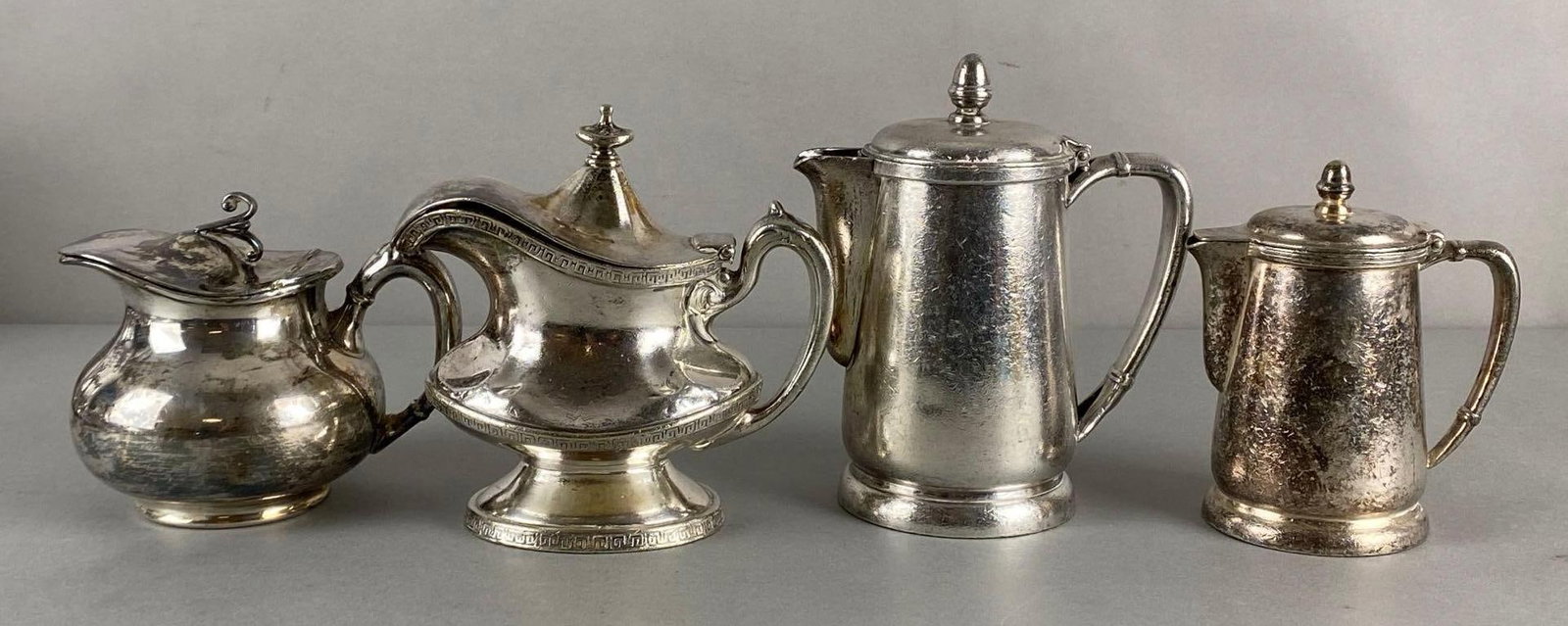 Group of 4 Illinois Central Railroad Silverplate Creamers and More: Includes Reed & Barton, Standard Silver Co, and International Silver Co, Largest measures 6 1/4 x 4 1/4 x 3 1/4 inches.
