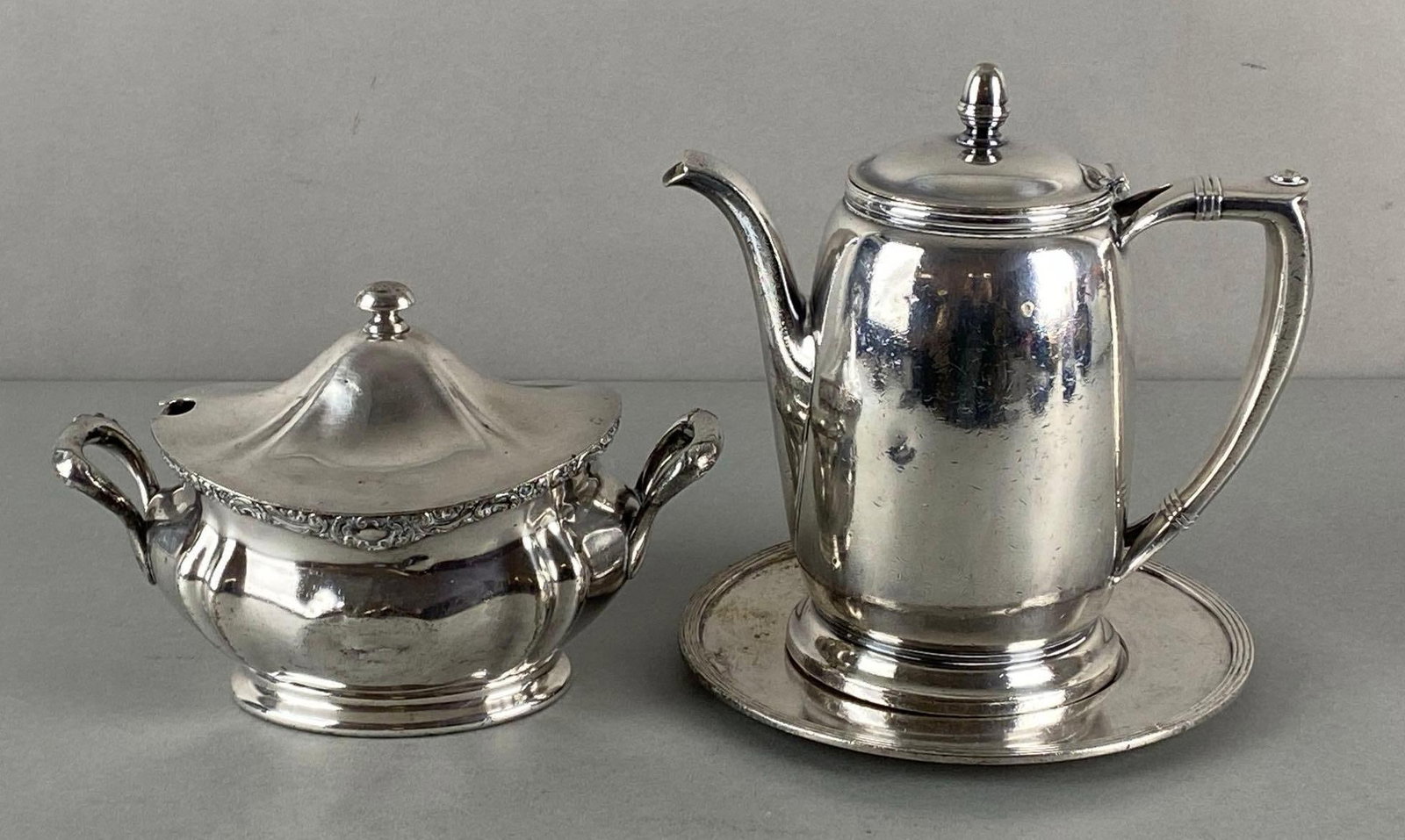 Group of 2 Railroad Silverplate Cream and Sugar Set: Includes International Silver Co. CMStP&P, and Reed & Barton CM&StP Railroads, Largest measures 7 x 7 1/2 x 4 inches.
