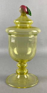 Steuben Yellow Vaseline Glass Candy Jar with Pear Top: Applied glass pear on top, Large crack along pedestal attachment point, Measures 13 1/2 x 6 x 6 inches.