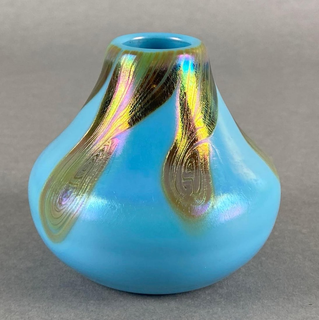 Lotton Opaline Blue Glass Bud Vase with Iridescent Gold Swirled Feather Motif: Measures 3 1/2 x 3 3/4 x 3 3/4 inches.