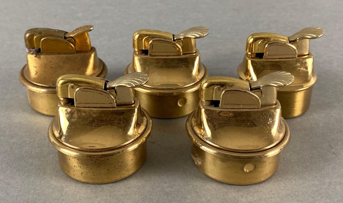 Group of 5 Whale Lever Table Top Brass Lighters: Unknown working condition, One marked Evans, All measure 1 3/4 x 1 3/4 x 1 3/4 inches.