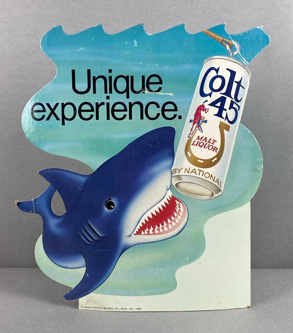 Colt 45 Malt Liquor Shark Cardboard Advertising Sign: Easel, scratches and bending throughout edges, measures 14 x 13 1/4 inches
