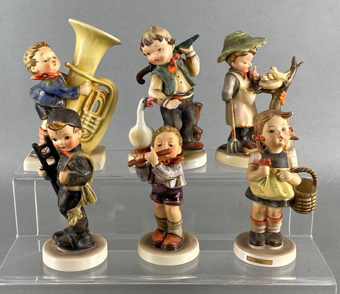 Group of 6 Hummel Porcelain Figurines: Goebel, Made in Germany, Includes Morning Concert, The Tuba Player, Hay Day, and more, Some chips and cracks, Largest measures 5 3/4 x 4 x 2 1/2 inches.