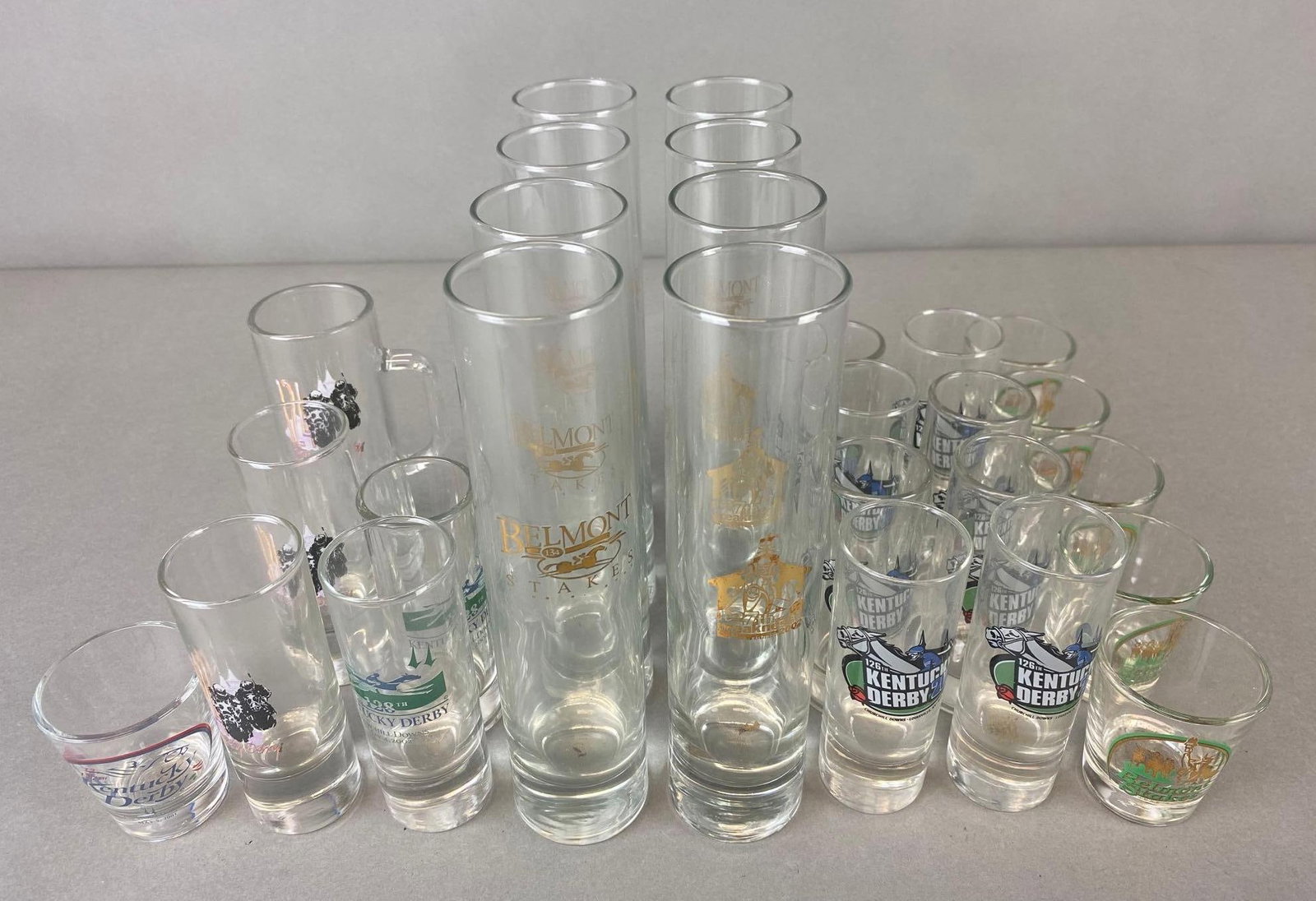 Group of Shot Glasses with Horse Racing: 27 total,includes Kentucky Derby, Belmont Stakes and Preakness. Long glasses measure 7 1/2 x 2 x 2 inches.