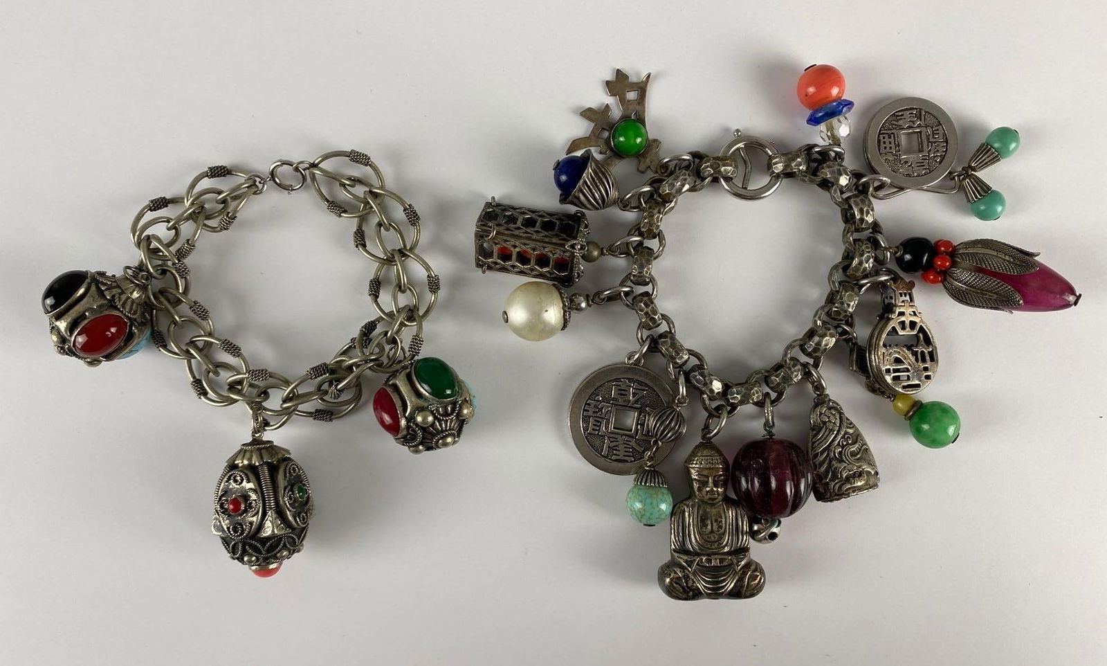 Group of 2 Charm Bracelets: Includes Napier Asian themed chunky charm bracelet, and Etruscan charm bracelet, Largest measures 6 inches long opened.