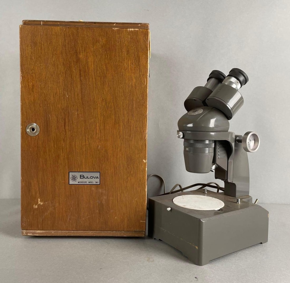 Bulova Model SM-1 Microscope with Case: Includes sw10x eyepiece. Working condition, case needs screws for bottom hinge. Wooden case measures 17 x 9 1/2 x 10 1/2 inches