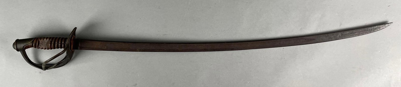 U.S. Civil War Cavalry Sword: Cracked wood handle. Stamped M, possibly Mansfield. Measures 40 1/2 inches with a 34 inch blade
