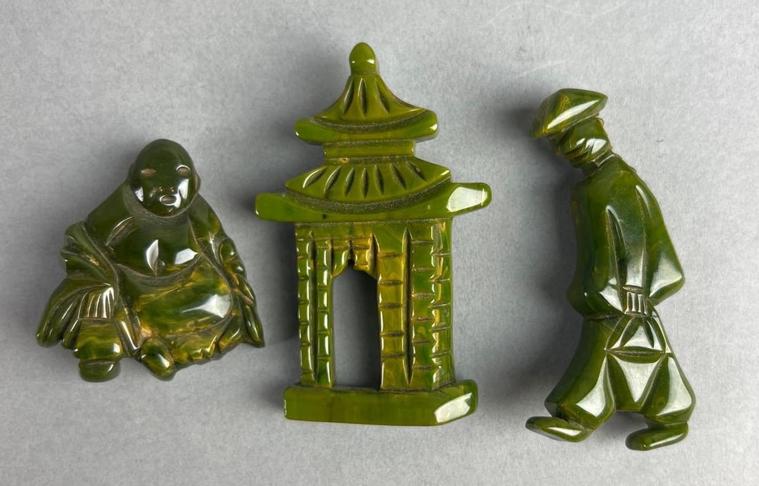 Group of 3 Green Bakelite Brooches: Includes Buddha, temple, and other. Temple measures 3 x 1 1/4 inches