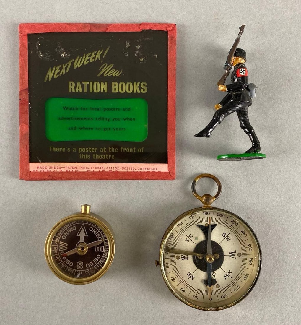 Group of 4 Assorted Items: Includes Valiant German WW2 Soldier Toy, (2) compasses, and Ration Books Glass Advertising Slide, Largest measures 3 1/4 x 3 1/4 inches.