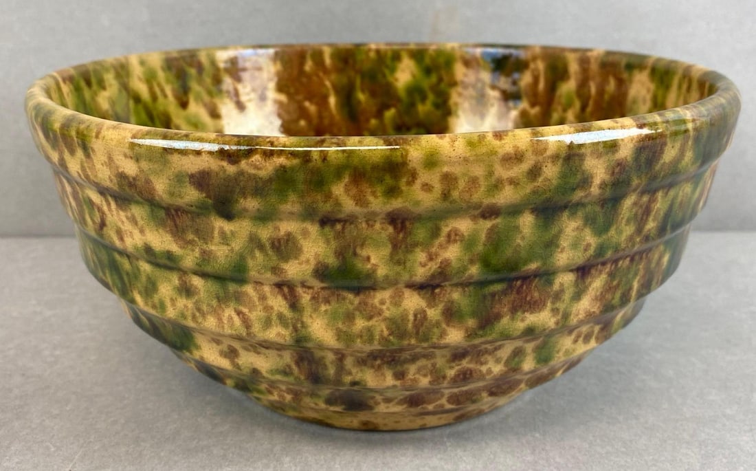 Green And Brown Spongeware Stoneware Mixing Bowl: Scratches throughout interior walls, measures 4 1/4 x 9 1/2 x 9 1/2 inches